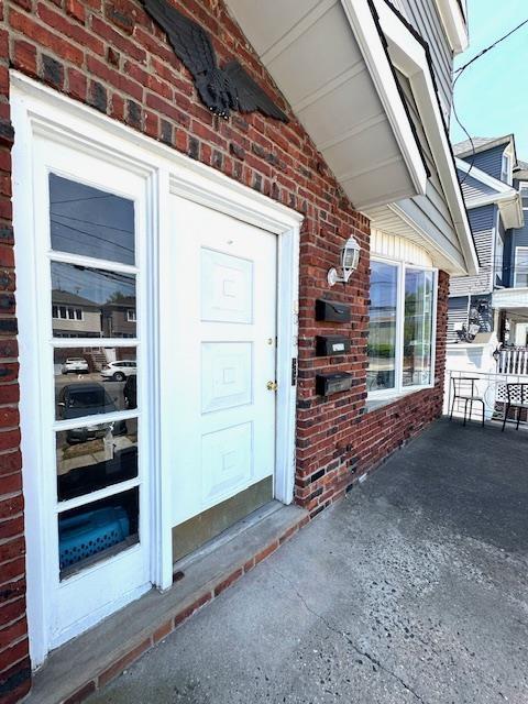 property entrance with brick siding