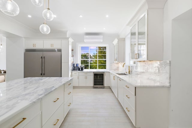 kitchen with high end refrigerator, beverage cooler, crown molding, and an AC wall unit