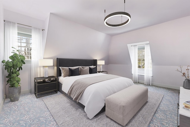 carpeted bedroom with baseboards and multiple windows