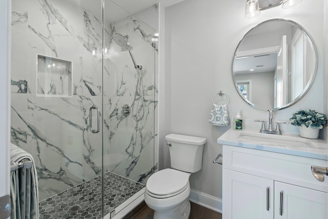 bathroom featuring vanity, toilet, and walk in shower