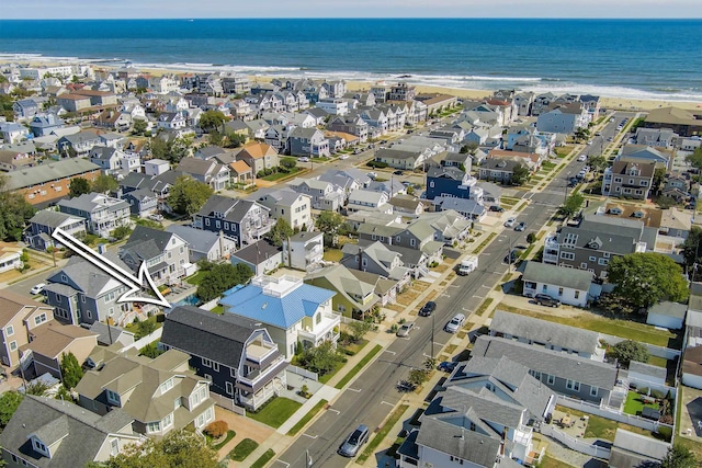 bird's eye view featuring a water view and a view of the beach