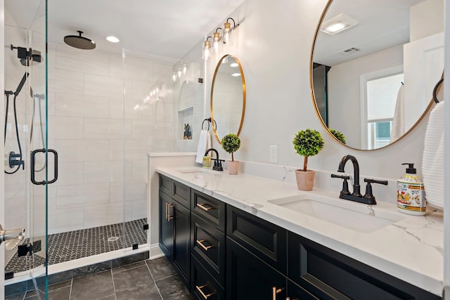 bathroom featuring tile patterned flooring, vanity, and an enclosed shower