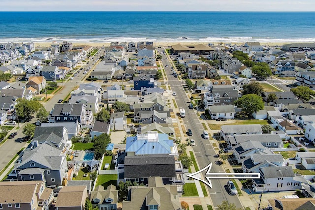 drone / aerial view with a water view and a view of the beach