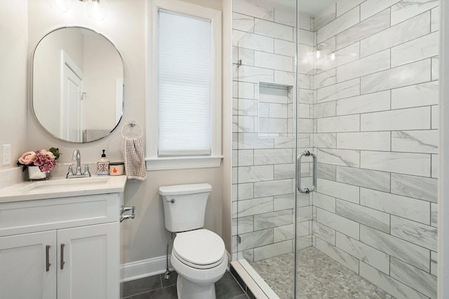 bathroom featuring tile patterned flooring, vanity, toilet, and a shower with door