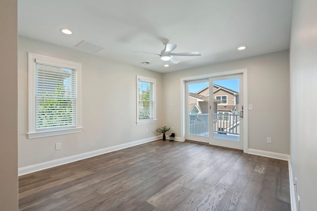 spare room featuring ceiling fan and dark wood-type flooring