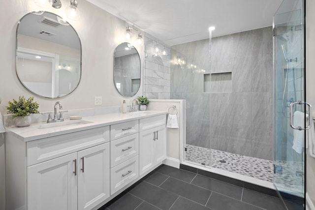 bathroom with tile patterned flooring, vanity, and an enclosed shower