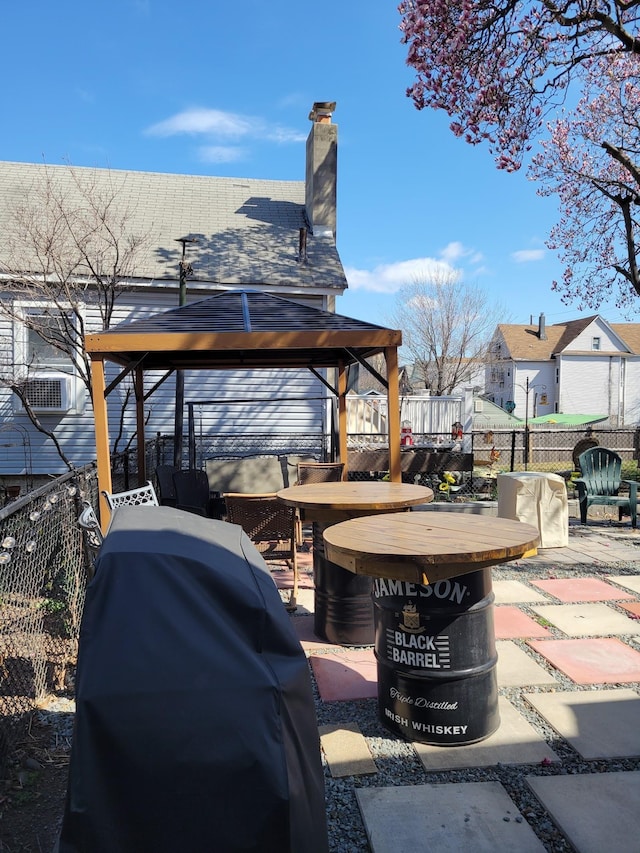 view of patio with a fenced backyard, a gazebo, and a grill