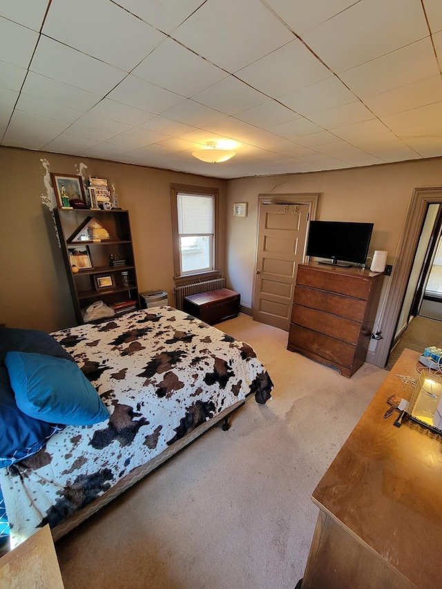 carpeted bedroom featuring radiator