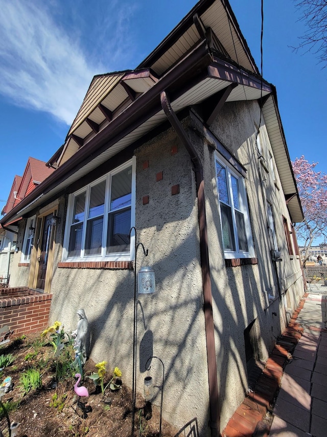view of side of property with stucco siding