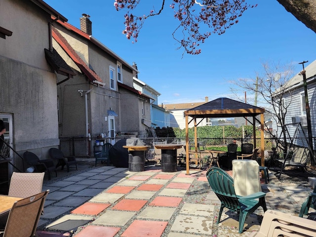 view of patio / terrace with fence and a gazebo
