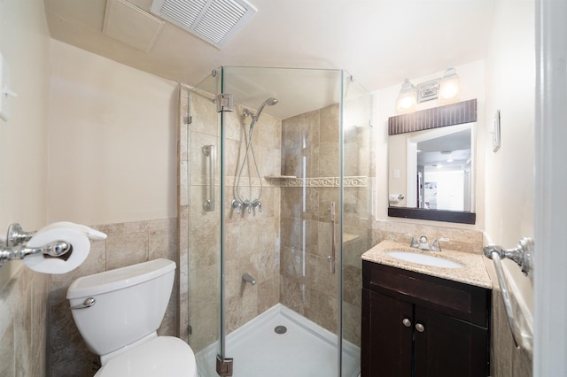25 Poplar St, Jersey City, NJ 07307 - bathroom with tile walls, vanity, a stall shower, and a wainscoted wall