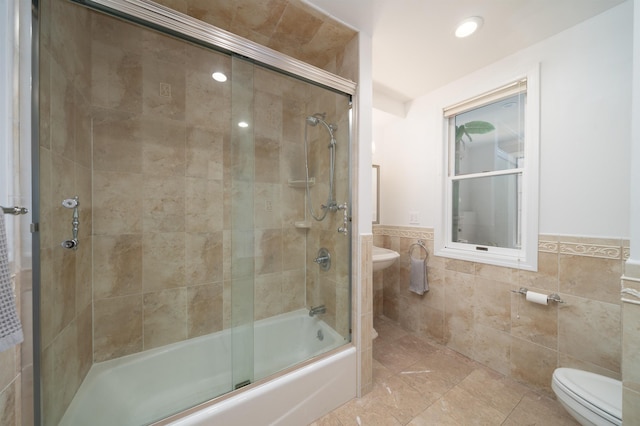 25 Poplar St, Jersey City, NJ 07307 - bathroom with tile walls, combined bath / shower with glass door, wainscoting, and recessed lighting