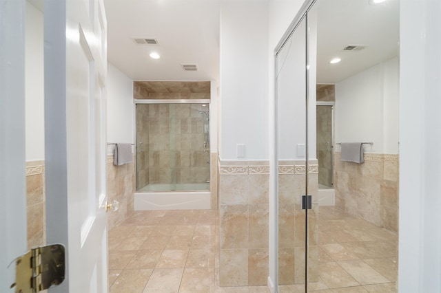 25 Poplar St, Jersey City, NJ 07307 - bathroom with tile walls, a wainscoted wall, enclosed tub / shower combo, tile patterned floors, and recessed lighting