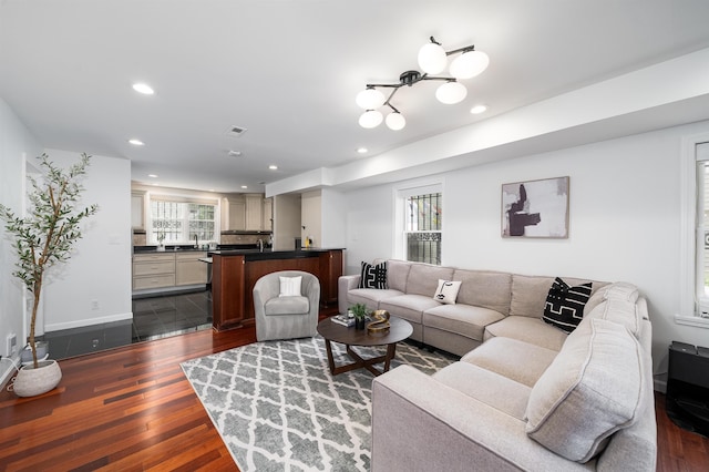 25 Poplar St, Jersey City, NJ 07307 - living area with dark wood-style flooring, recessed lighting, healthy amount of natural light, and a chandelier