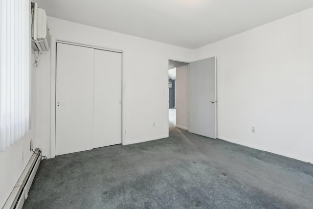unfurnished bedroom with a closet, carpet, a baseboard heating unit, and an AC wall unit