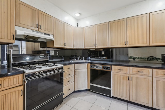 kitchen with gas range, dark countertops, dishwasher, under cabinet range hood, and light tile patterned flooring