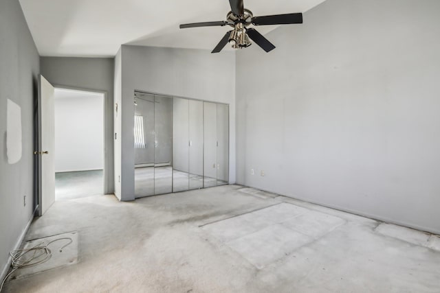 unfurnished bedroom with carpet flooring, ceiling fan, high vaulted ceiling, a baseboard radiator, and a closet