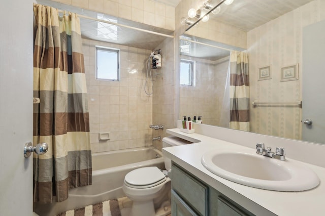 bathroom featuring vanity, toilet, and shower / bath combination with curtain