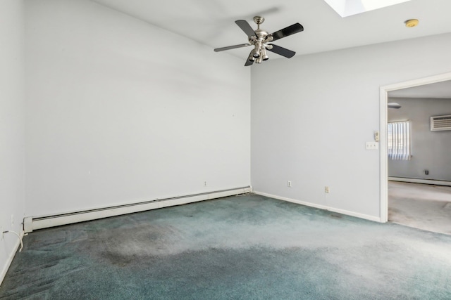 carpeted empty room with a skylight, baseboards, ceiling fan, and a baseboard heating unit