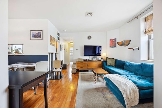 living room with visible vents and wood finished floors