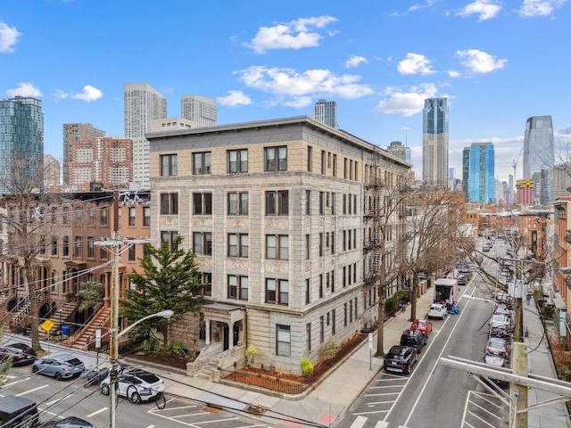 view of building exterior featuring a view of city and uncovered parking