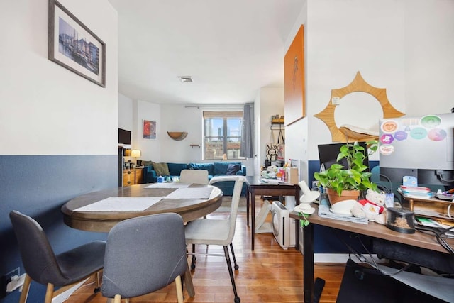 dining space with visible vents and wood finished floors