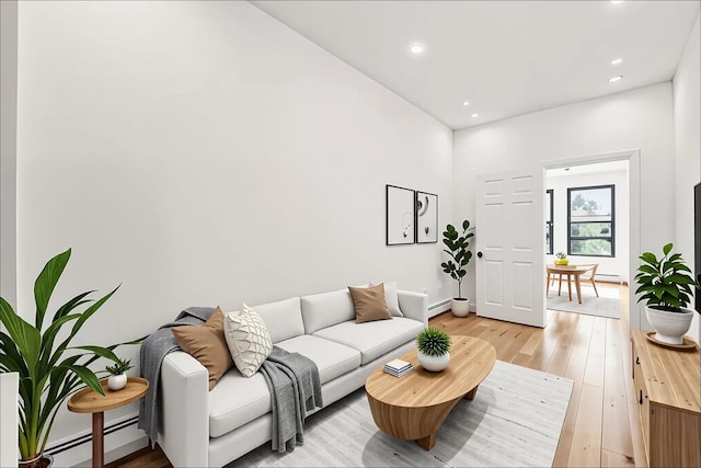 138 Leonard St Unit 2R, Jersey City, NJ 07307 - living area with baseboard heating, light wood-style flooring, recessed lighting, and baseboards