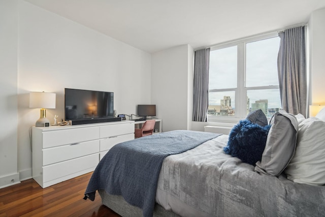 bedroom with dark wood-type flooring