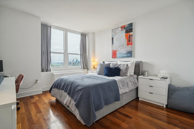 bedroom with dark wood-type flooring