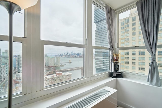 interior details with radiator heating unit and a water view