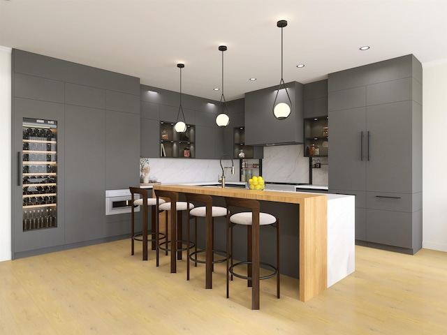 209 6th St, Hoboken, NJ 07030 - bar with tasteful backsplash, hanging light fixtures, light wood finished floors, and a sink