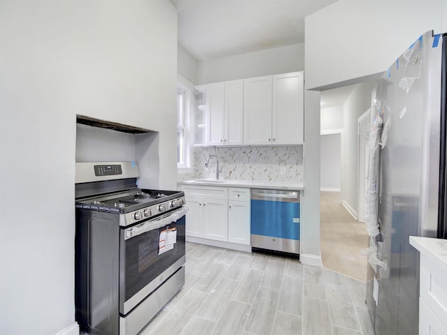 33 Duer Pl, Weehawken, NJ 07086 - kitchen with appliances with stainless steel finishes, white cabinetry, open shelves, and light countertops