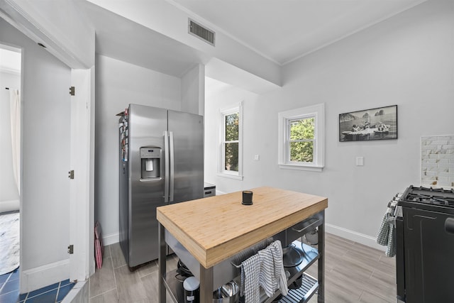 33 Duer Pl, Weehawken, NJ 07086 - kitchen featuring stainless steel refrigerator with ice dispenser, range with gas cooktop, ornamental molding, and wood finish floors