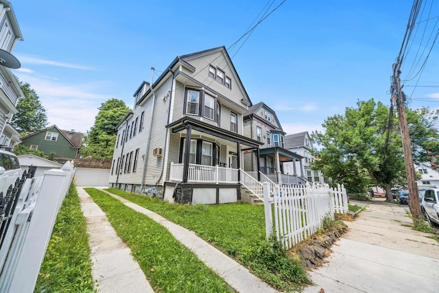 33 Duer Pl, Weehawken, NJ 07086 - view of front of property featuring a porch, a fenced front yard, and a garage