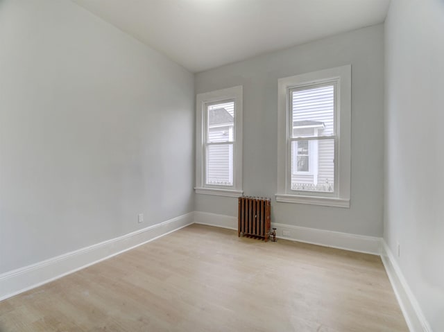 33 Duer Pl, Weehawken, NJ 07086 - empty room with radiator heating unit and light wood finished floors