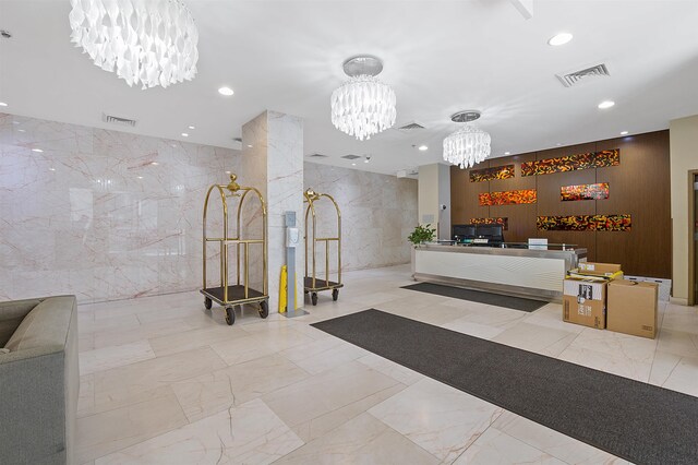 10 Regent St Unit 308, Jersey City, NJ 07302 - reception with a chandelier, recessed lighting, and tile walls