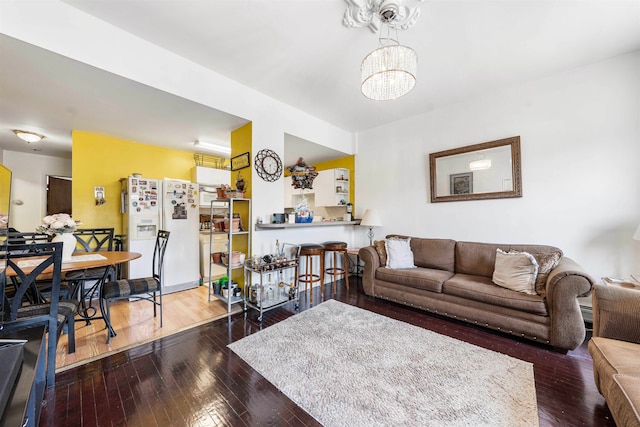 living room with a chandelier and hardwood / wood-style floors