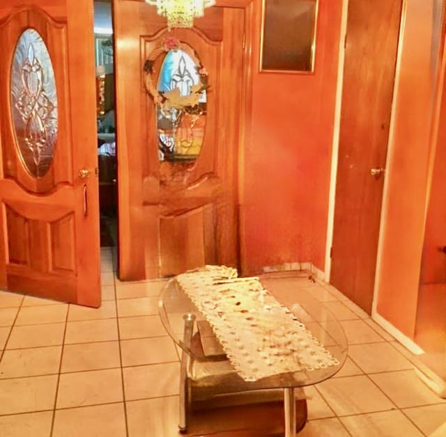 535 27th St, Union City, NJ 07087 - foyer entrance with light tile patterned floors and a chandelier