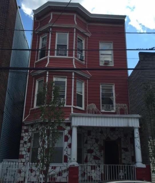 535 27th St, Union City, NJ 07087 - view of front facade featuring a porch and stone siding