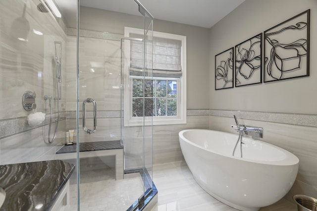 bathroom featuring independent shower and bath and tile walls