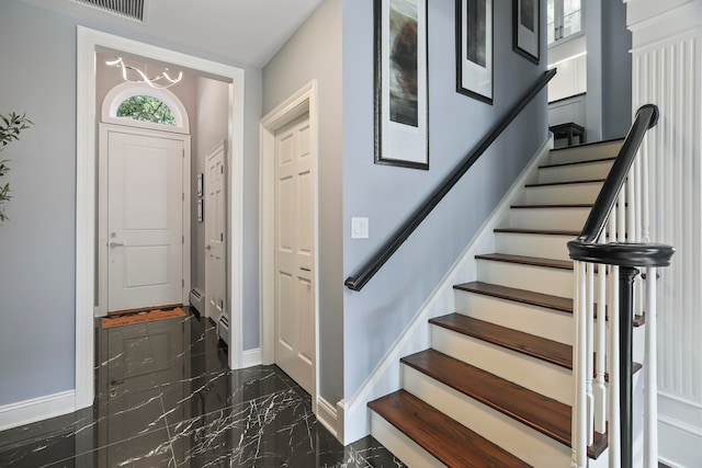 foyer entrance featuring a baseboard heating unit