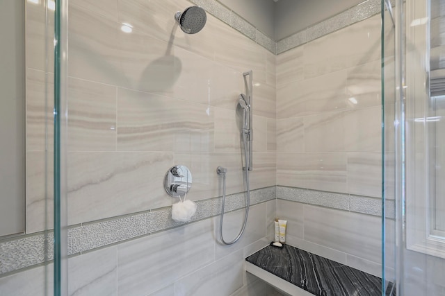 bathroom featuring tile walls and a tile shower