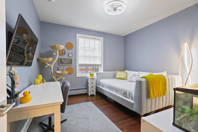 bedroom with dark wood-type flooring and baseboard heating