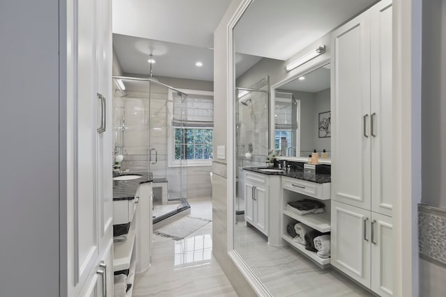 bathroom with an enclosed shower and vanity