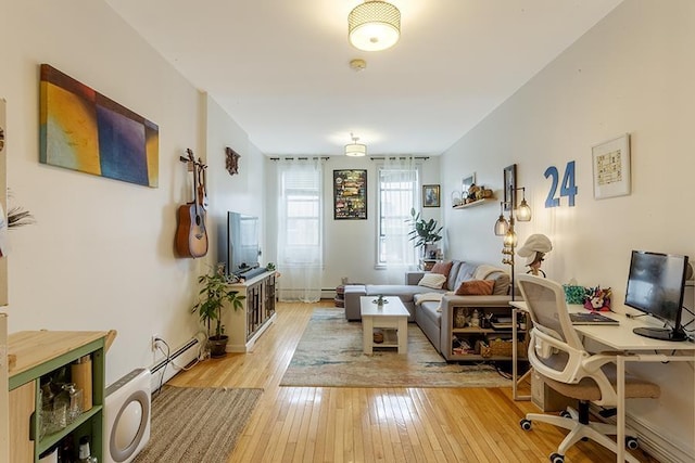 home office with light wood-type flooring and a baseboard radiator