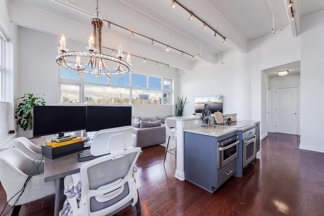 kitchen featuring pendant lighting, dark wood-type flooring, black electric cooktop, and stainless steel oven