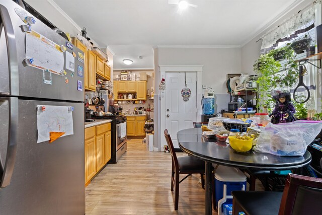 kitchen with light brown cabinetry, light wood-type flooring, appliances with stainless steel finishes, and crown molding