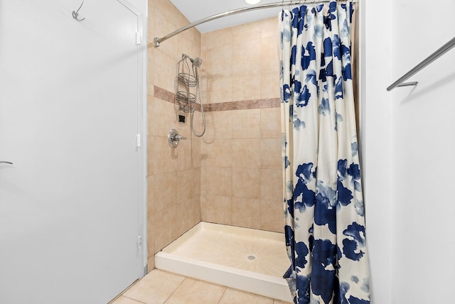 bathroom with tile patterned floors and a stall shower