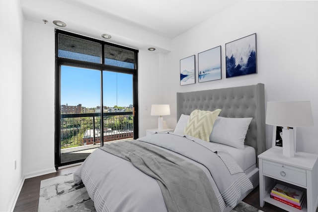 bedroom featuring baseboards and wood finished floors
