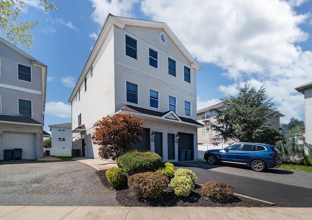 view of front of property with an attached garage and aphalt driveway